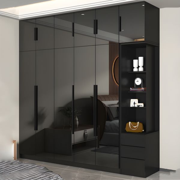 Sleek black glass wardrobe with multiple panels reflecting natural light in a modern bedroom